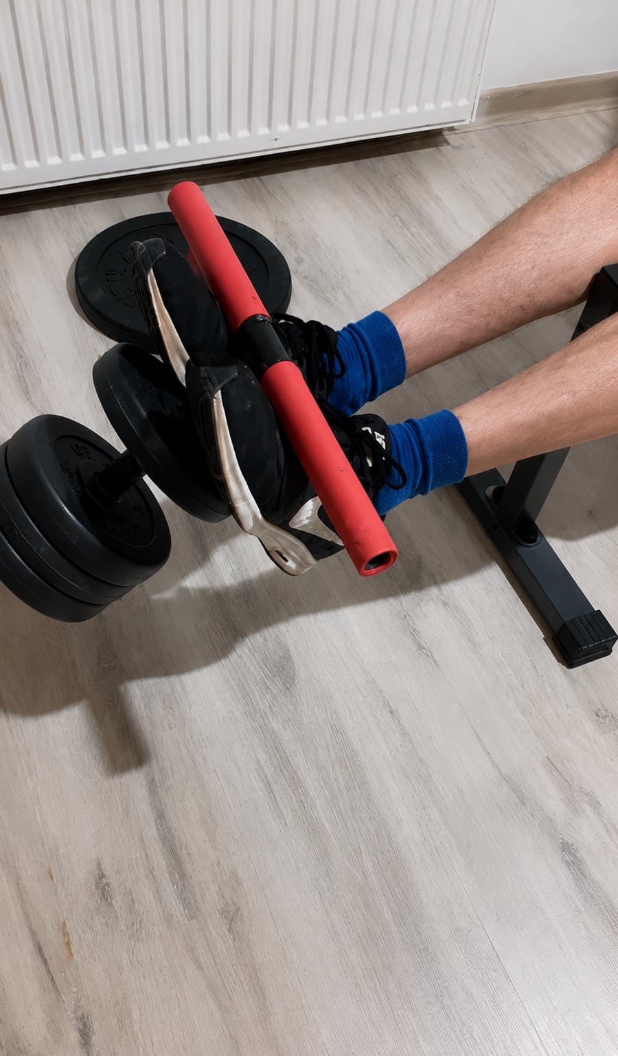 A weighted tibialis trainer being tested from a chair